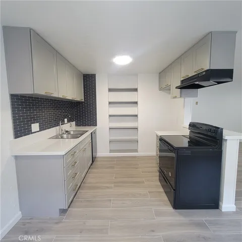 a utility room with cabinets washer and dryer