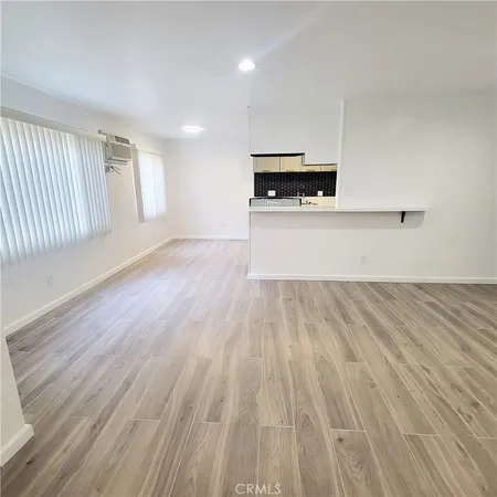 a view of kitchen with microwave and cabinets