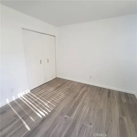 a view of a room with wooden floor and bench