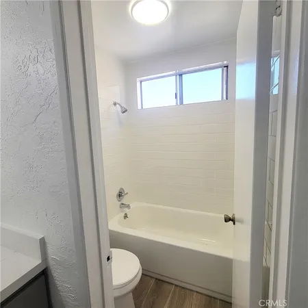 a bathroom with a bathtub toilet and sink