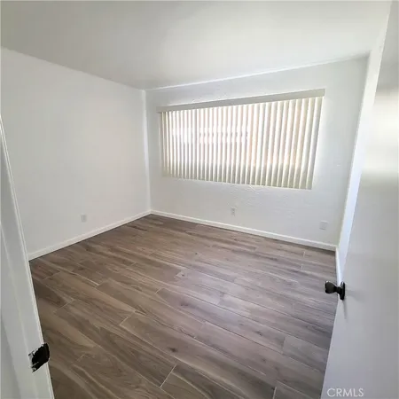 a view of a room with wooden floor and window