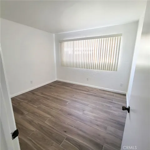 a view of a room with wooden floor and window