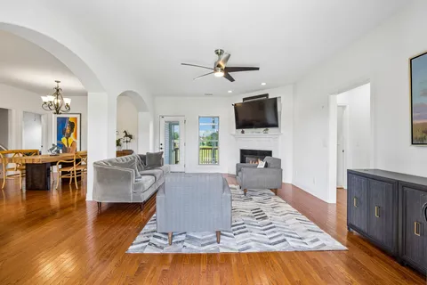 a living room with fireplace furniture and a flat screen tv