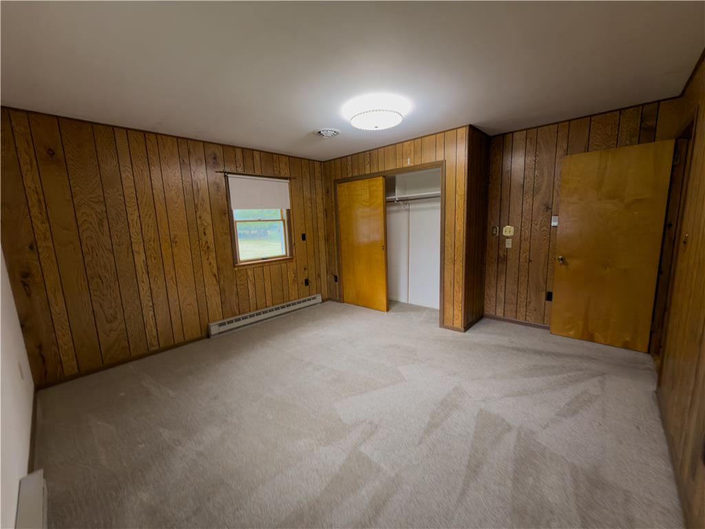 134 Bangor Junction Road Bangor, PA 18013 - Photo 12 of 18 Classic wood-paneled walls and neutral carpeting define this comfortable bedroom space.