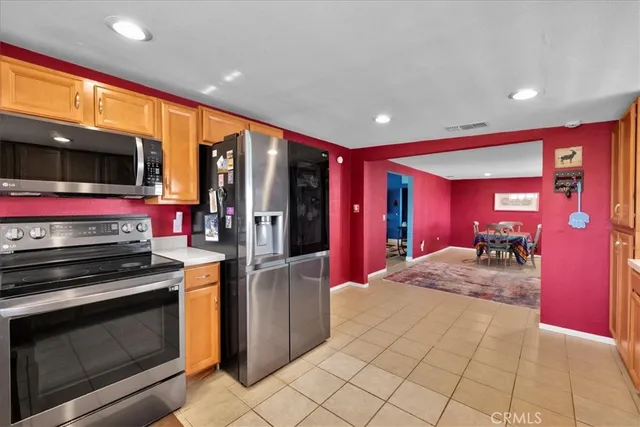 a bedroom with a bed and a dresser next to a window