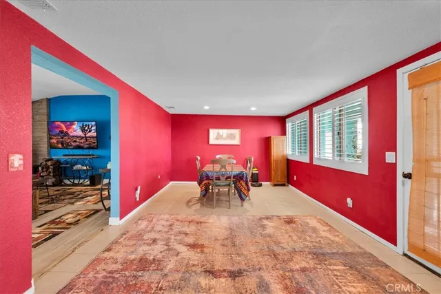 a bathroom with a granite countertop sink a toilet a mirror and shower