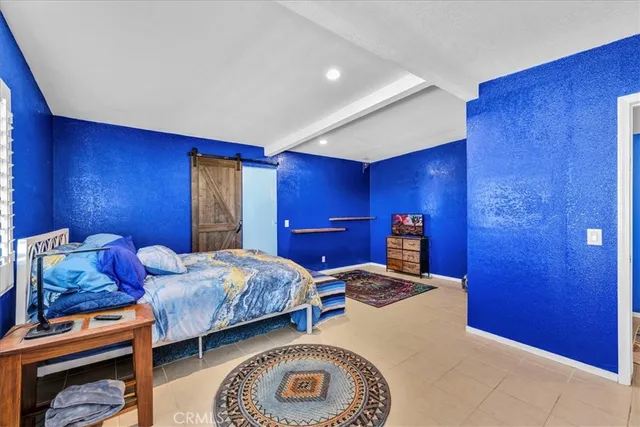 a living room with furniture and a open kitchen space