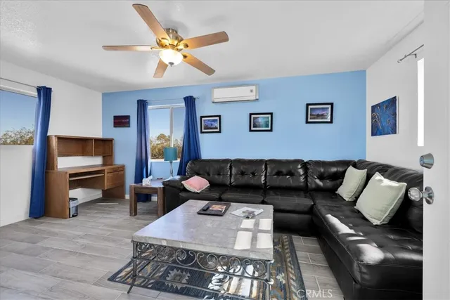 a view of a house with a yard and potted plants