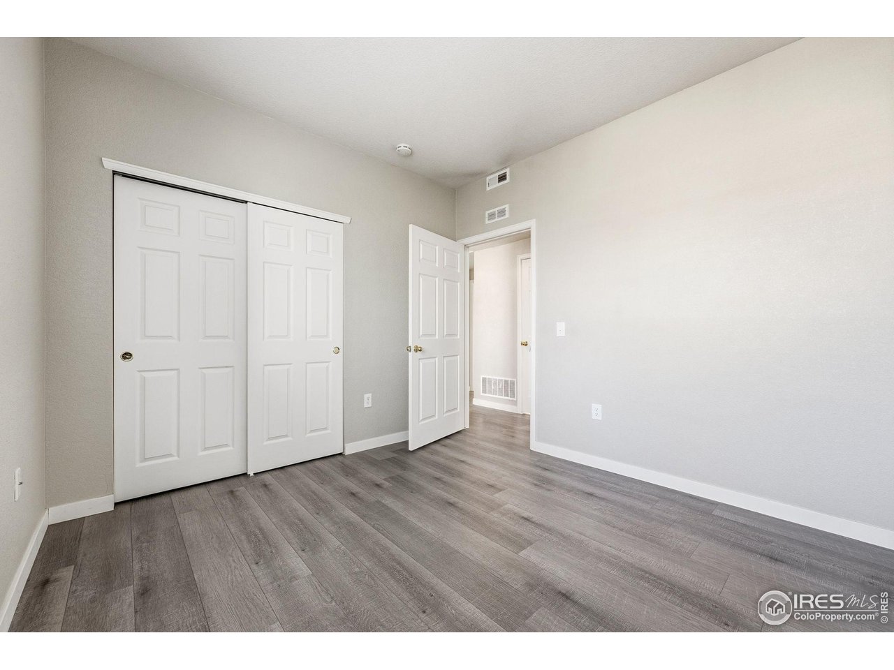 4501 Nelson Road, Unit 2404 Longmont, CO 80503 - Photo 17 of 23 a view of an empty room with wooden floor