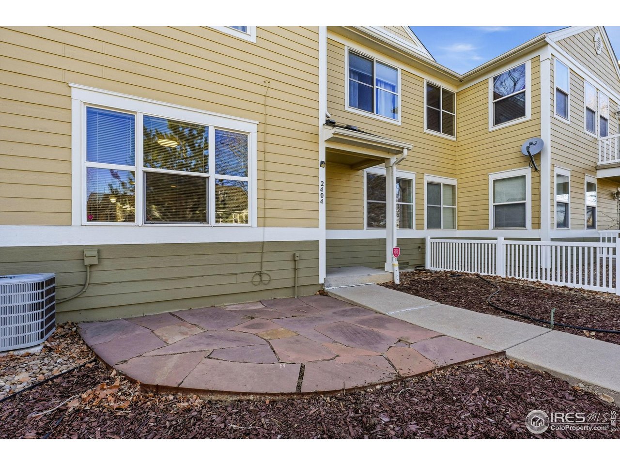 4501 Nelson Road, Unit 2404 Longmont, CO 80503 - Photo 22 of 23 a view of a house with a backyard