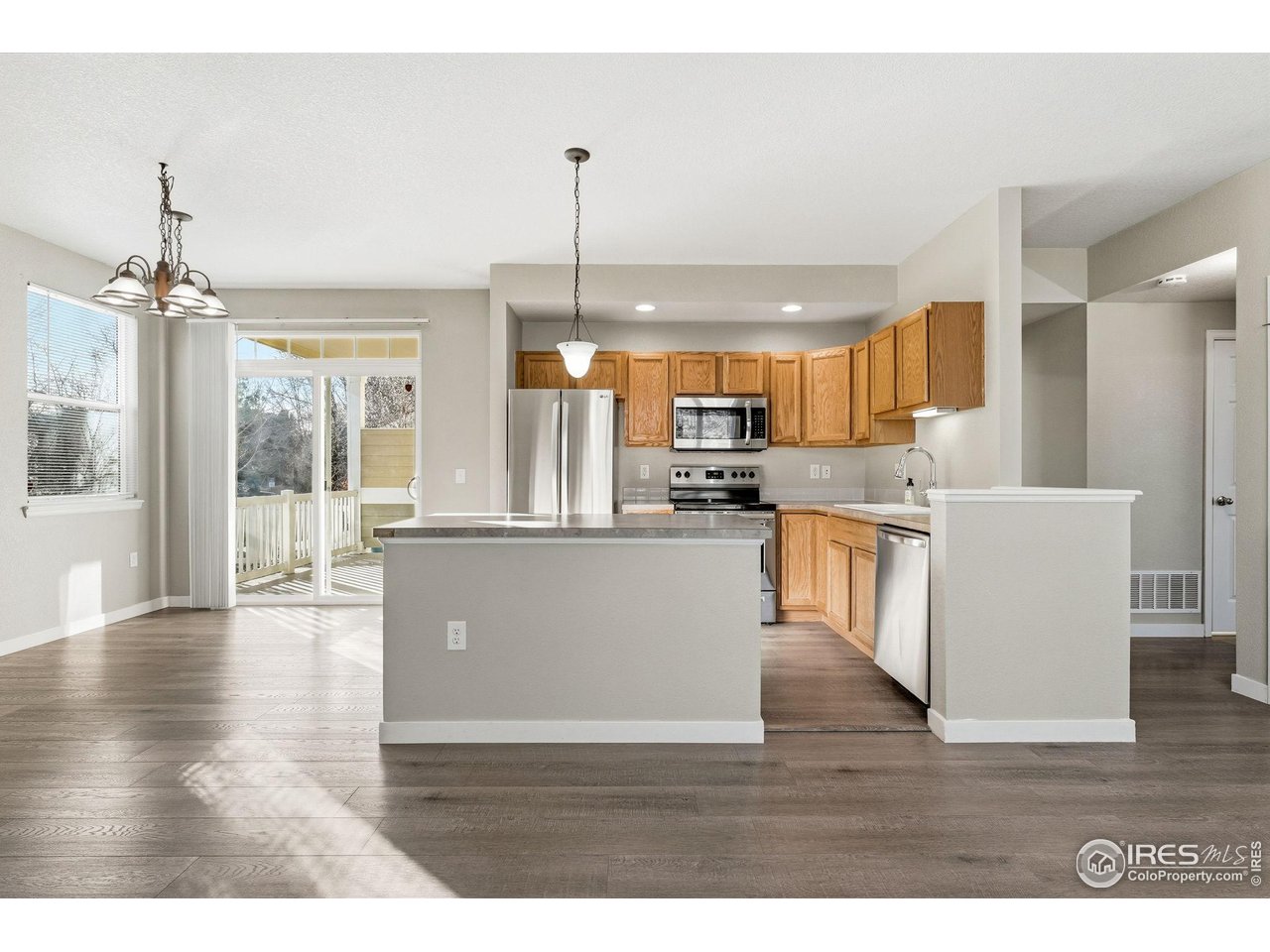 4501 Nelson Road, Unit 2404 Longmont, CO 80503 - Photo 4 of 23 a view of a kitchen with furniture and wooden floor