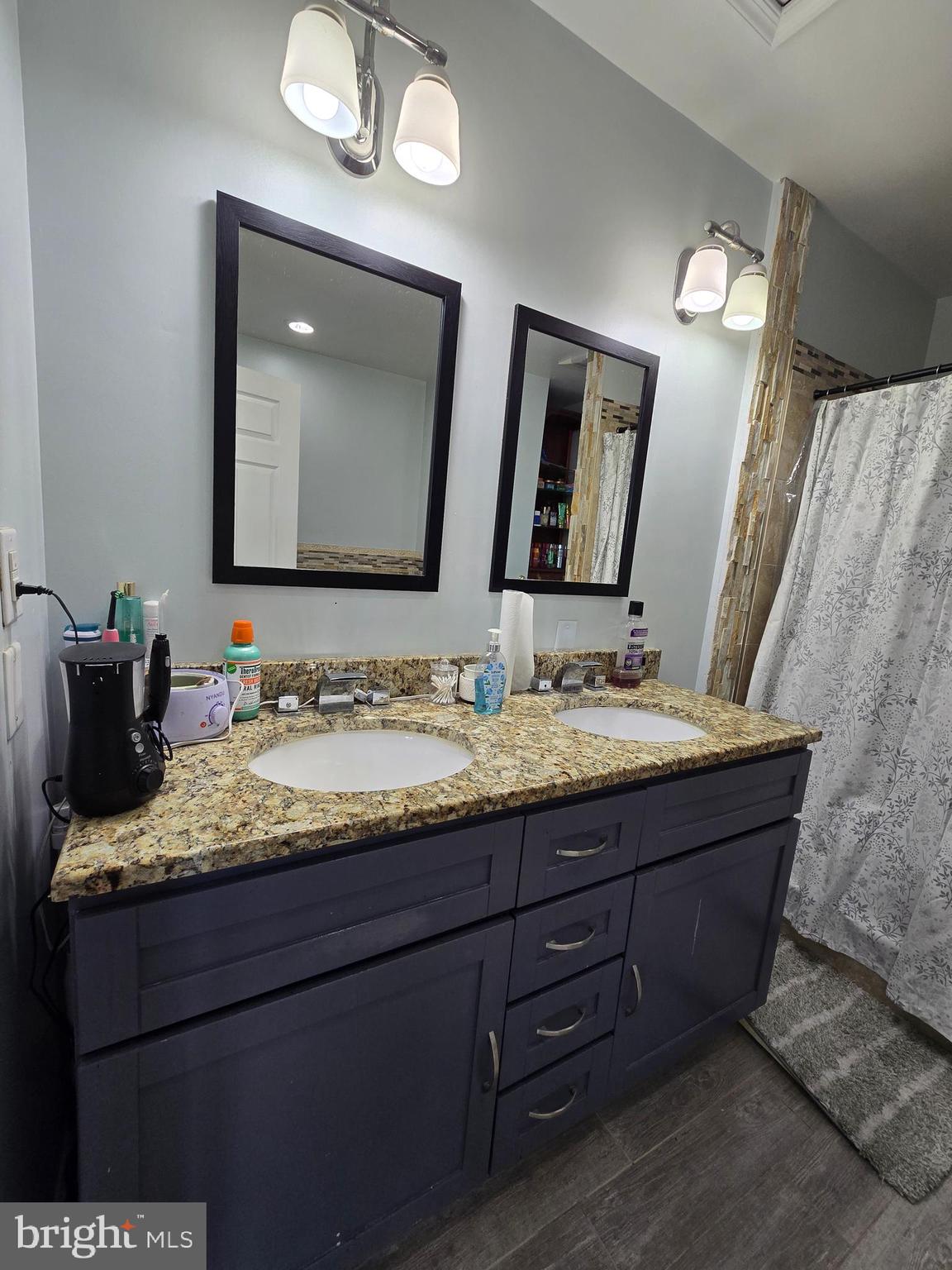 7513 Saffron Court Hanover, MD 21076 - Photo 26 of 42 a bathroom with a granite countertop double vanity sink and a mirror