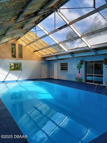 a view of yellow house with pool