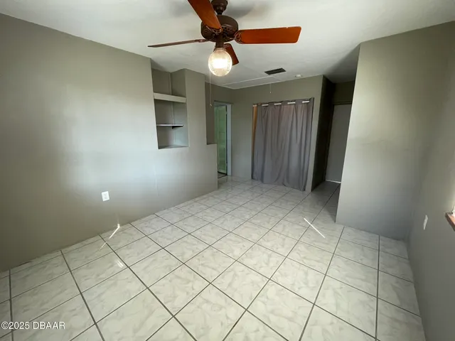 a view of an empty room and a window