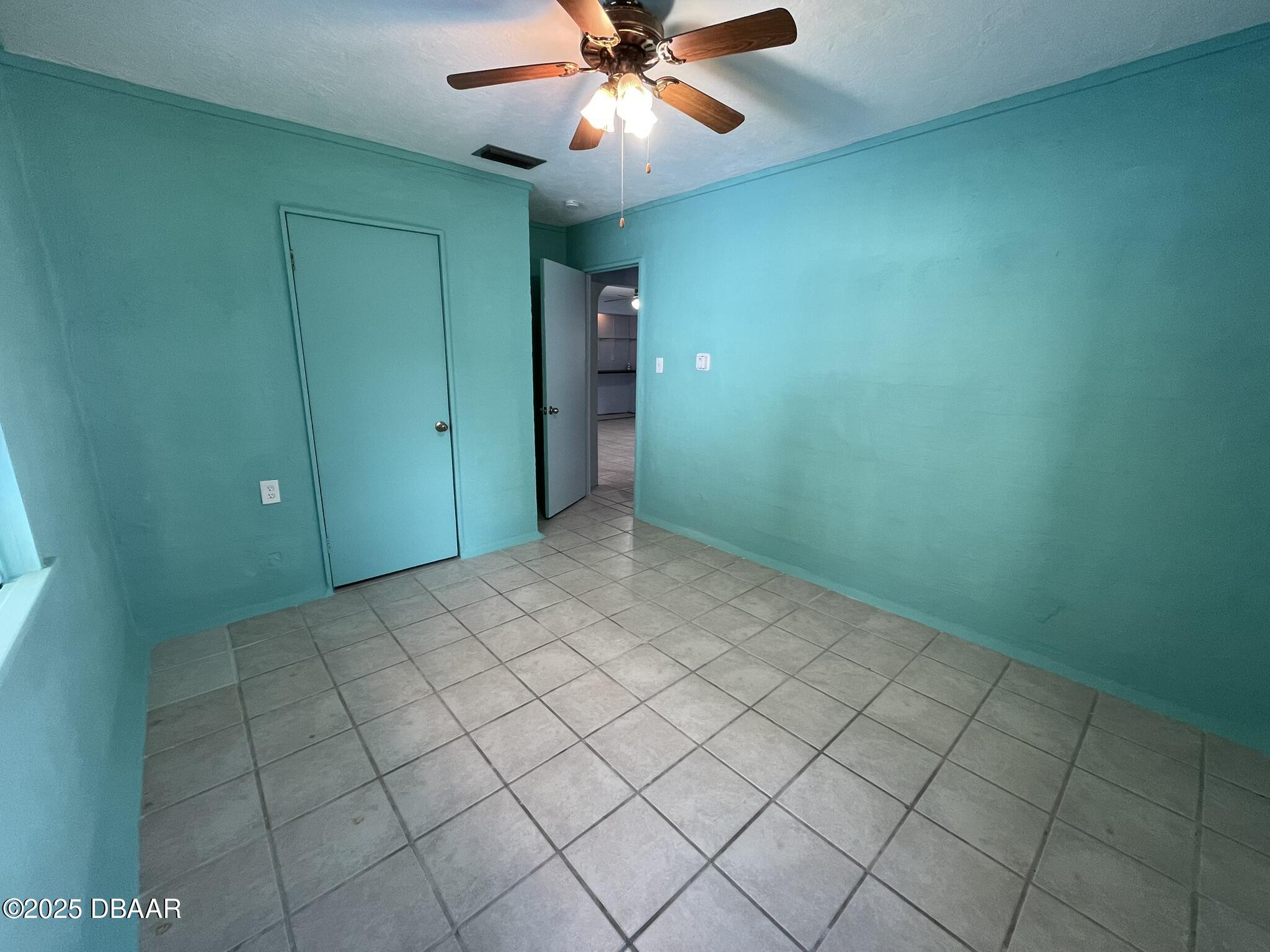 113 Fox Place Port Orange, FL 32127 - Photo 22 of 40 an empty room with closet and fan