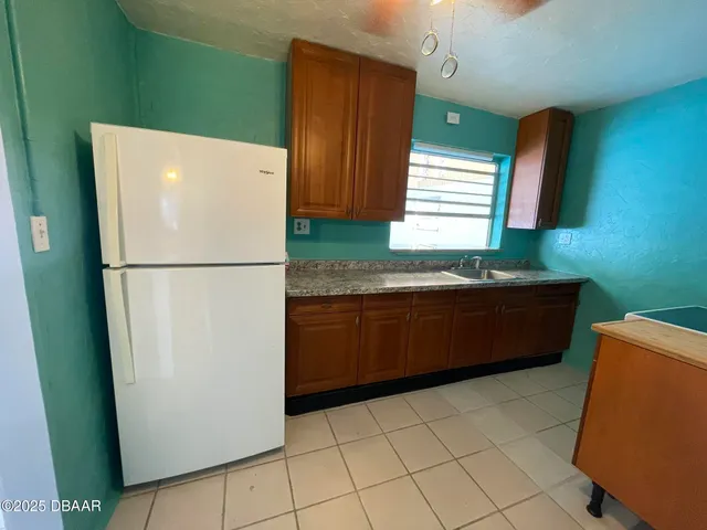a kitchen with a refrigerator and a sink