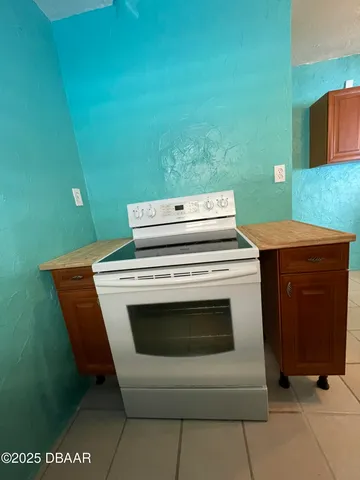 a stove top oven sitting inside of a kitchen