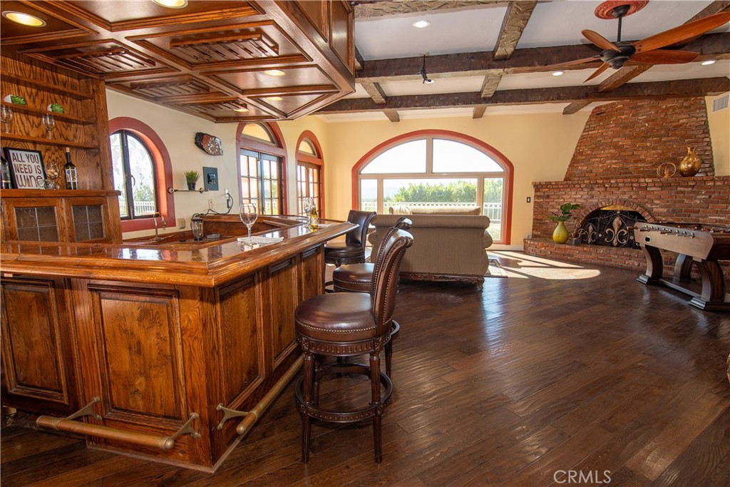 10425 Melvin Avenue Porter Ranch, CA 91326 - Photo 11 of 61 a view of a livingroom with furniture wooden floor a fireplace and windows