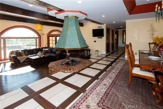 a living room with patio furniture and a floor to ceiling window