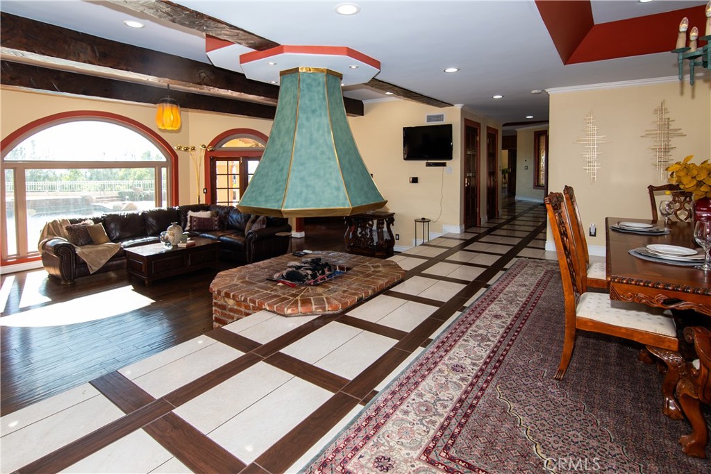 10425 Melvin Avenue Porter Ranch, CA 91326 - Photo 12 of 61 a living room with furniture and a flat screen tv