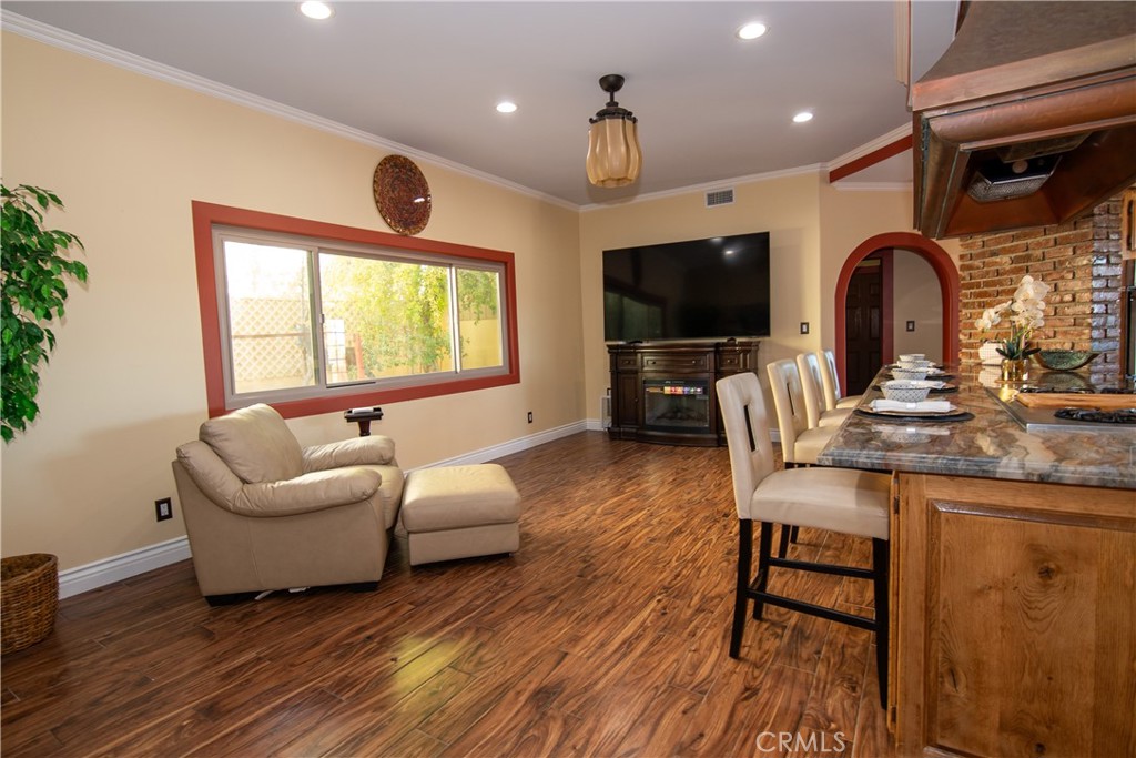 10425 Melvin Avenue Porter Ranch, CA 91326 - Photo 22 of 61 a living room with furniture a flat screen tv and a large window