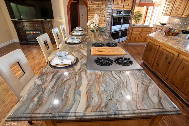 a bathroom with a granite countertop sink and a window