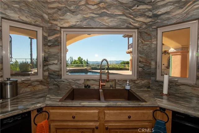 a bathroom with a sink a light fixture and a mirror