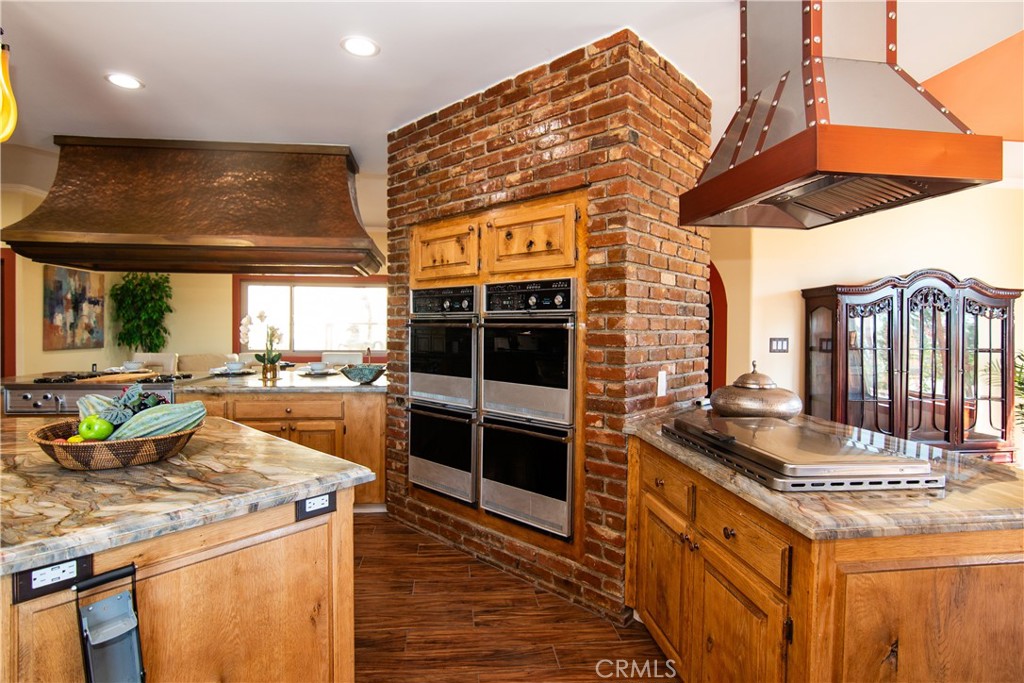 10425 Melvin Avenue Porter Ranch, CA 91326 - Photo 32 of 61 a kitchen with stainless steel appliances granite countertop a stove and a refrigerator