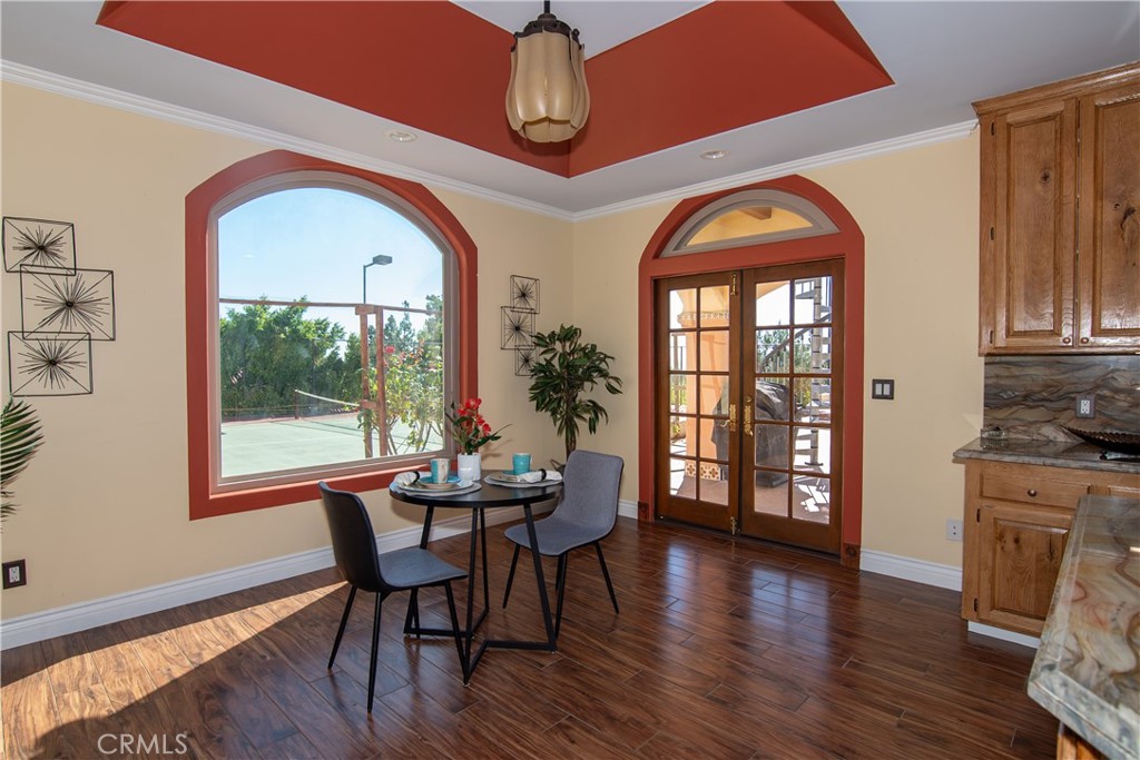 10425 Melvin Avenue Porter Ranch, CA 91326 - Photo 33 of 61 a view of a dining room with furniture window and wooden floor