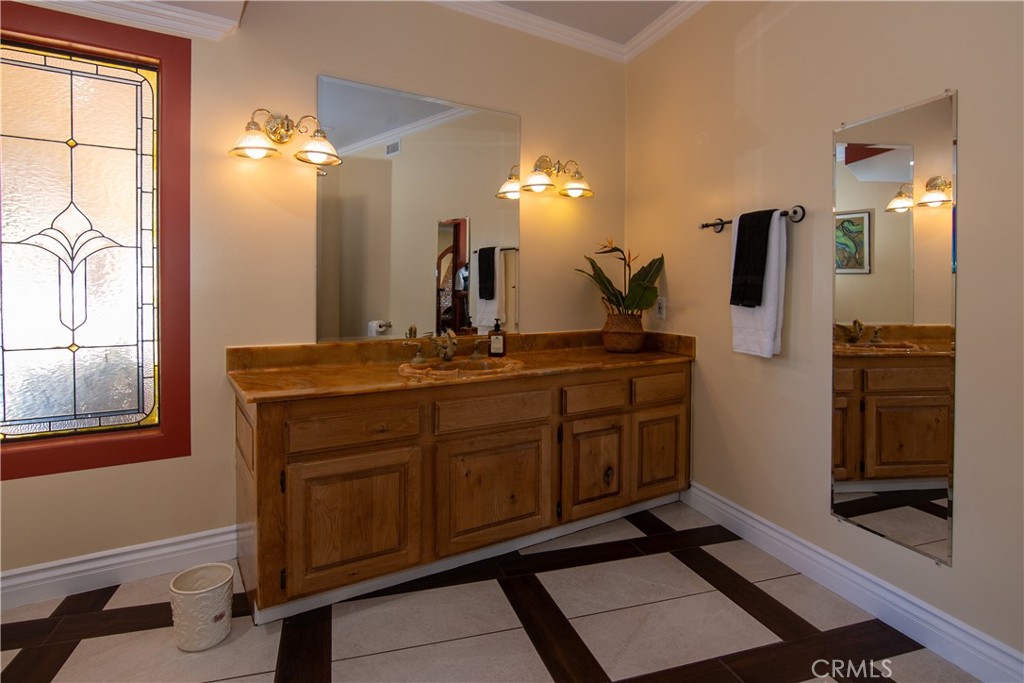 10425 Melvin Avenue Porter Ranch, CA 91326 - Photo 37 of 61 a bathroom with a sink a light fixture and a mirror