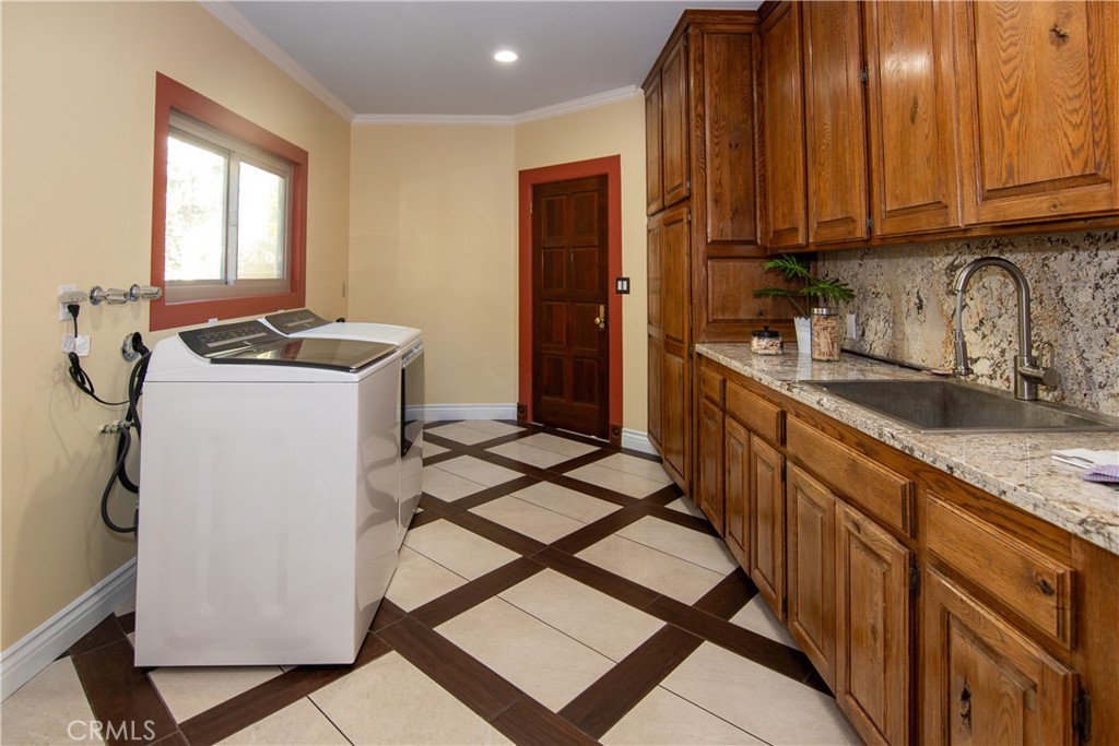10425 Melvin Avenue Porter Ranch, CA 91326 - Photo 38 of 61 a kitchen with a sink a stove cabinets and a window