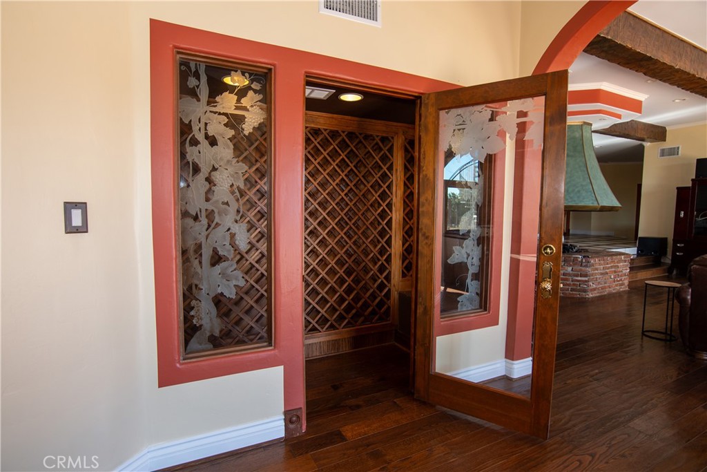 10425 Melvin Avenue Porter Ranch, CA 91326 - Photo 4 of 61 a view of a hallway with wooden floor and living room