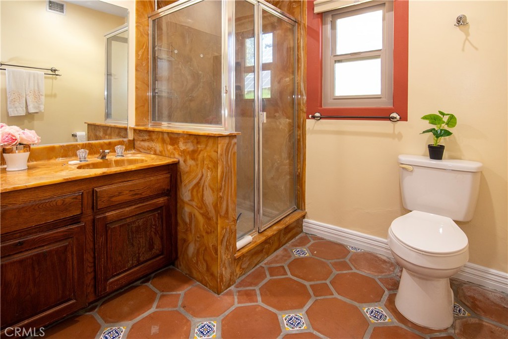 10425 Melvin Avenue Porter Ranch, CA 91326 - Photo 41 of 61 a bathroom with a granite countertop sink toilet and shower