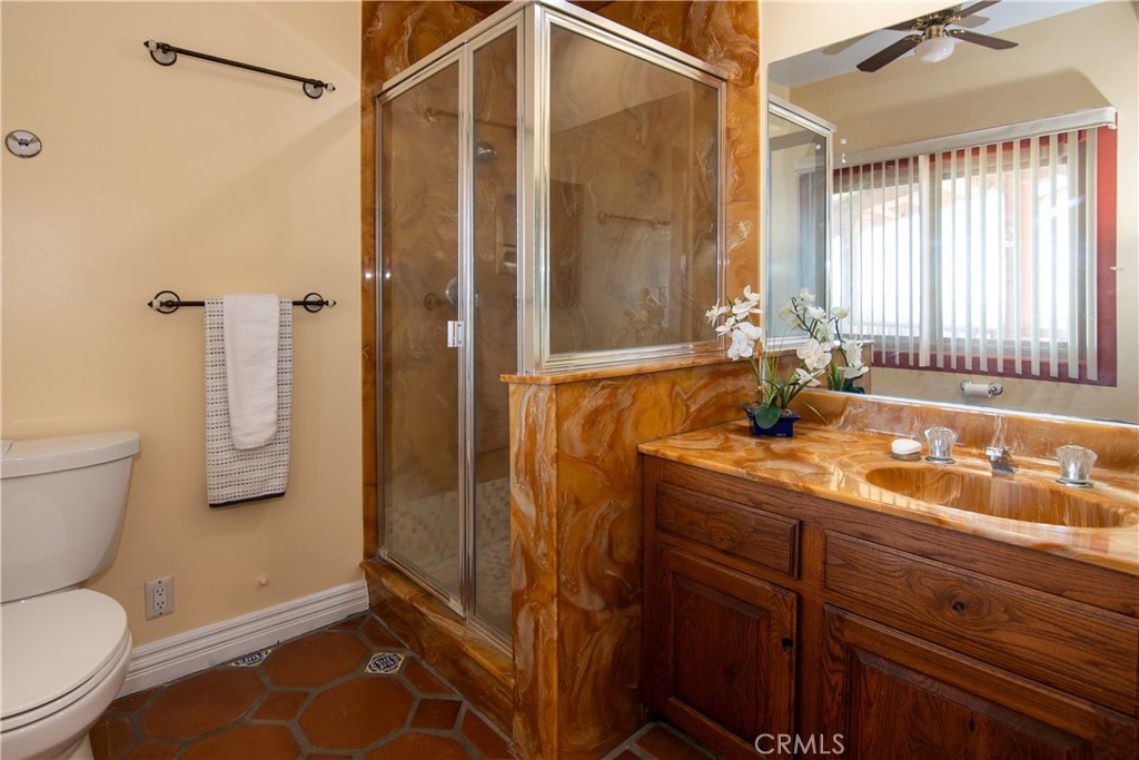 10425 Melvin Avenue Porter Ranch, CA 91326 - Photo 56 of 61 a bathroom with a sink a toilet and shower
