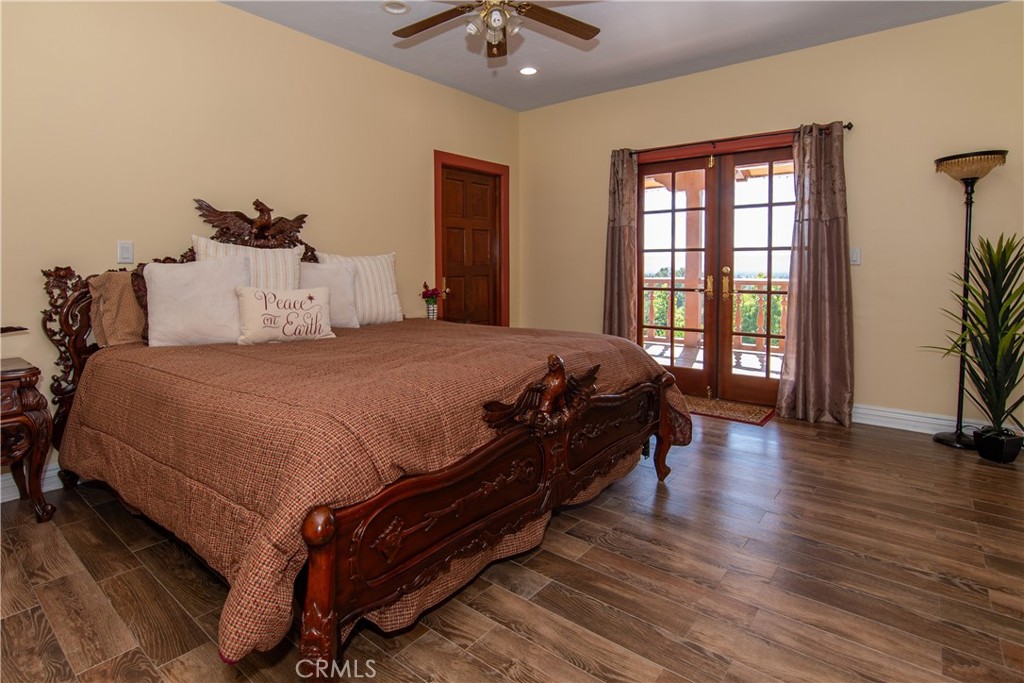 10425 Melvin Avenue Porter Ranch, CA 91326 - Photo 57 of 61 a bedroom with a bed and wooden floor