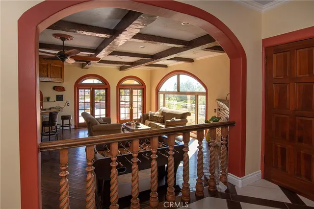 a living room with furniture a fireplace and wooden floor