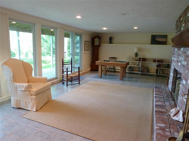 505 Scraggy Neck Road Cataumet, MA 02534 - Photo 18 of 33 a living room with furniture and a fireplace