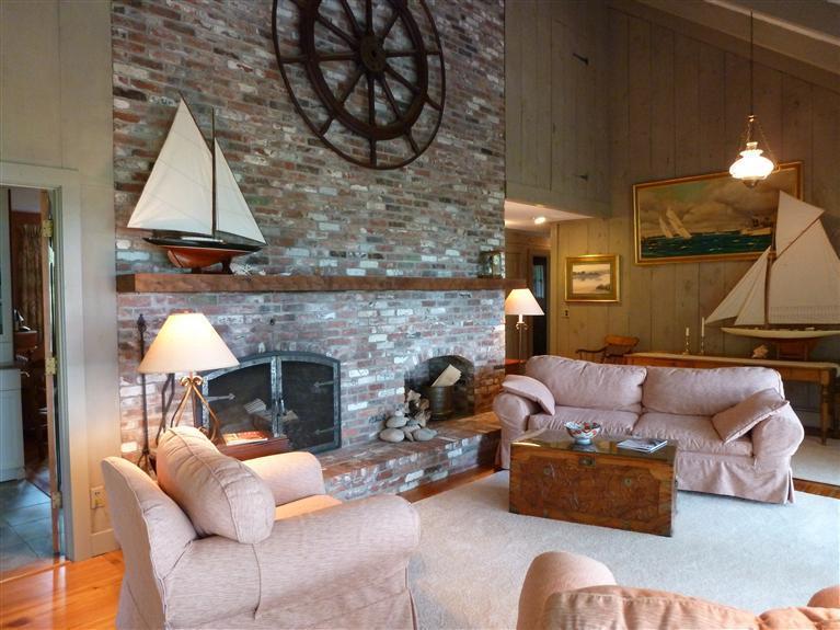 505 Scraggy Neck Road Cataumet, MA 02534 - Photo 7 of 33 a living room with furniture and a fireplace