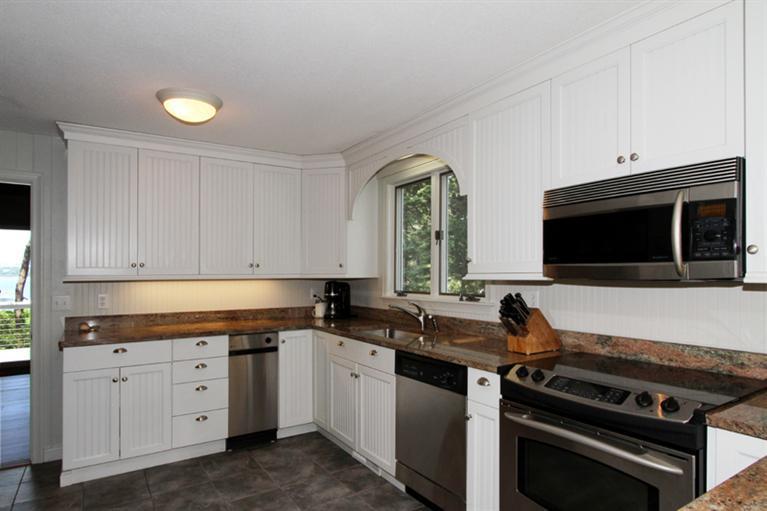 505 Scraggy Neck Road Cataumet, MA 02534 - Photo 10 of 33 a kitchen with granite countertop a stove and a sink