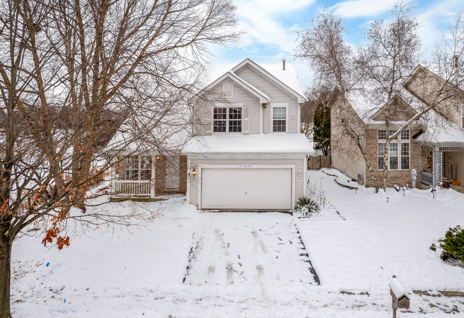 a view of a white house covered in snow
