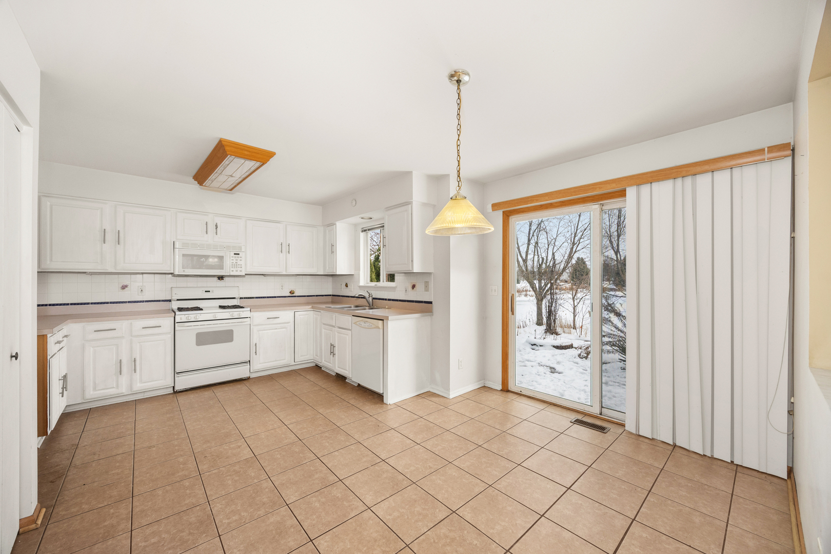 14252 South Hemingway Circle Plainfield, IL 60544 - Photo 13 of 36 a kitchen with white cabinets and white appliances