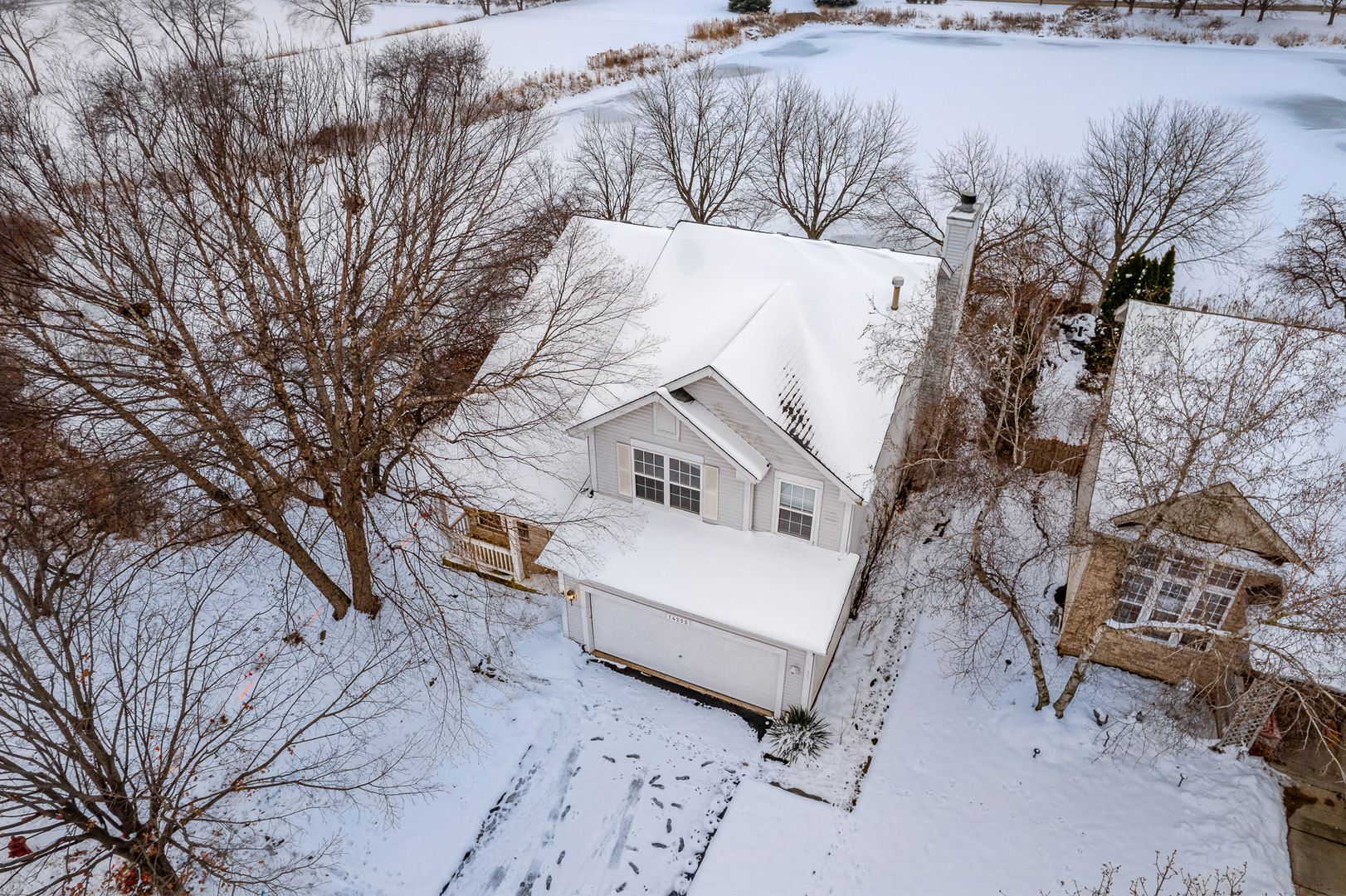 14252 South Hemingway Circle Plainfield, IL 60544 - Photo 2 of 36 a view of a house with a snow in the yard
