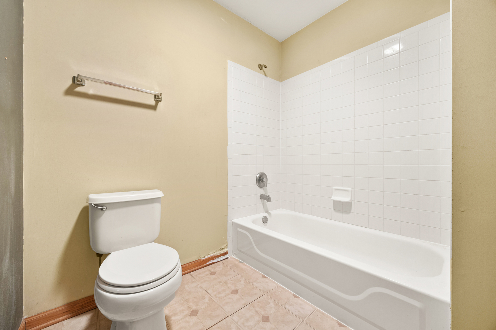 14252 South Hemingway Circle Plainfield, IL 60544 - Photo 27 of 36 a white toilet sitting next to a bath tub