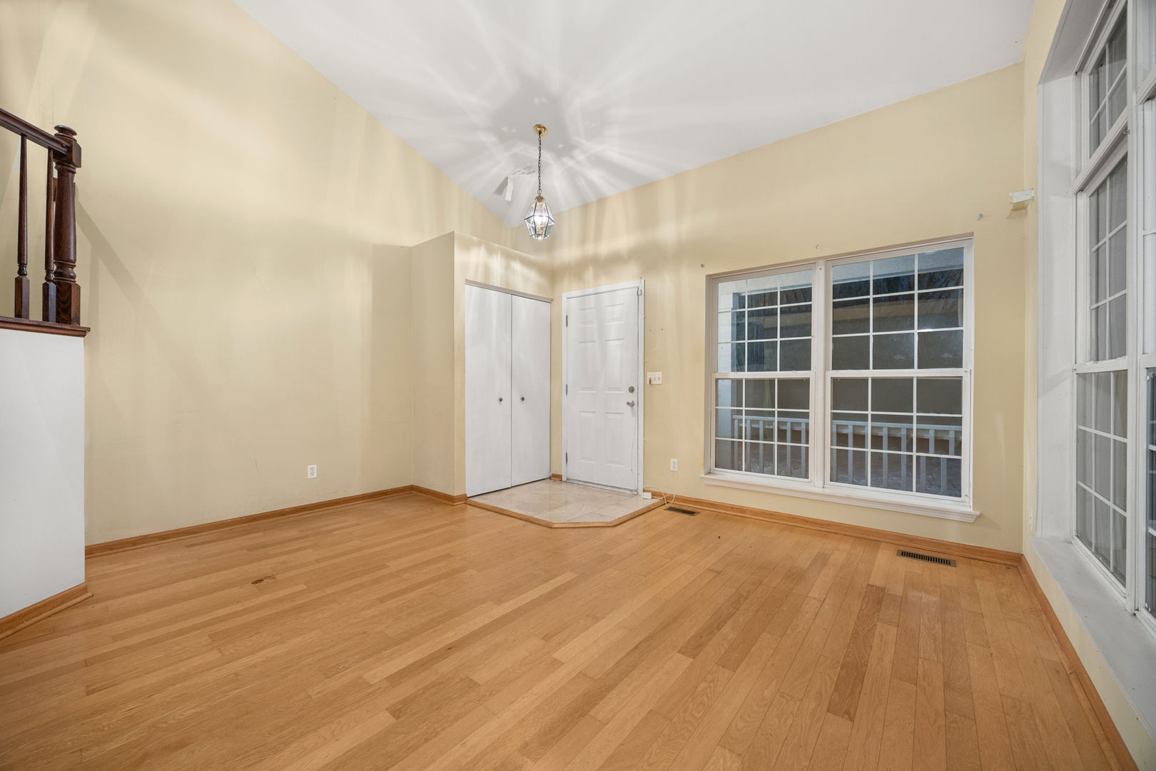 14252 South Hemingway Circle Plainfield, IL 60544 - Photo 10 of 36 a view of an empty room with a window and wooden floor