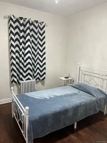 a bedroom with a bed and a mirror