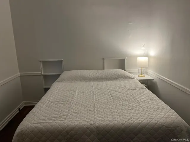 a large bed sitting in a bedroom next to a lamp