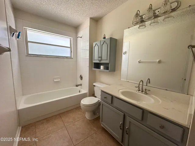 a bathroom with a sink mirror toilet and bathtub