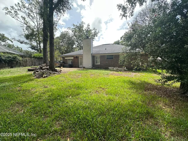 a backyard of a house with table and chairs