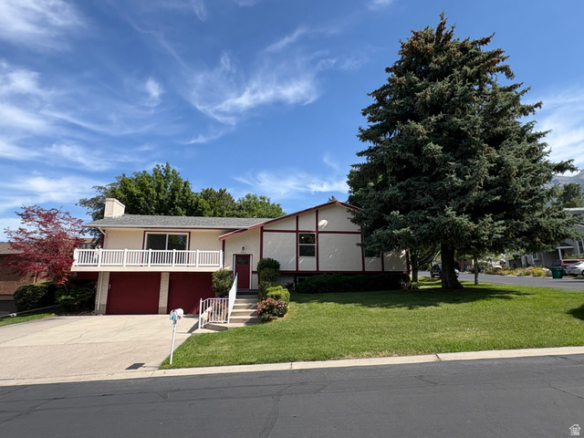 595 Meadowlark Road Orem, UT 84097 - Photo 1 of 87 Split-level residence featuring a prominent balcony, dual garage doors, and a front yard with established landscaping