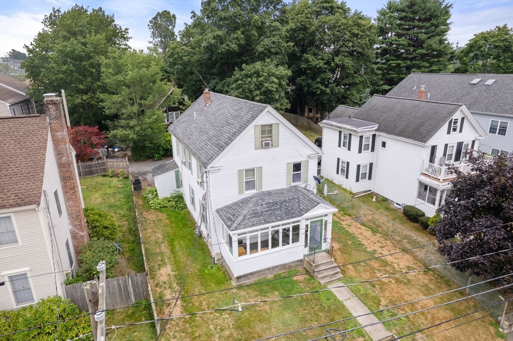 an aerial view of residential houses with yard and trees
